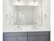 Bathroom featuring a gray vanity with dual sinks, a large mirror, and modern fixtures at 735 Breakers Reef Ln, Huger, SC 29450