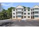 Attractive apartment building with multiple levels, balconies, and designated parking at 7413 Indigo Palms Way, Johns Island, SC 29455