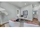 Bright home office features a modern white desk, hardwood flooring, and natural light from the window at 7413 Indigo Palms Way, Johns Island, SC 29455