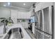 Bright kitchen with stainless steel appliances, white cabinets, and a stylish island sink at 7413 Indigo Palms Way, Johns Island, SC 29455