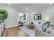 Cozy living room with a large window, comfortable seating, and elegant interior design at 7413 Indigo Palms Way, Johns Island, SC 29455