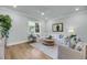 Bright living room with a large window, comfortable seating, and elegant interior design at 7413 Indigo Palms Way, Johns Island, SC 29455
