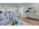Open living area featuring hardwood floors, comfortable seating, and stylishly decorated console at 7413 Indigo Palms Way, Johns Island, SC 29455