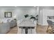 Dining area featuring a large table, hardwood floors, and decorative plants at 7432 Indigo Palms Way, Johns Island, SC 29455