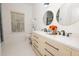Well-lit bathroom featuring double sinks, modern fixtures, and gold framed mirrors, complemented by a marble countertop at 760 Natchez Circle Cir, Mount Pleasant, SC 29464