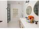 Bright bathroom showcasing double sinks, stylish fixtures, and a glass-enclosed shower, all with a window at 760 Natchez Circle Cir, Mount Pleasant, SC 29464