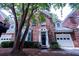Charming brick home with a black front door, two-car garage, and mature tree in the front yard at 760 Natchez Circle Cir, Mount Pleasant, SC 29464