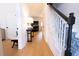 Bright foyer featuring hardwood floors, staircase with patterned runner and black handrail, and elegant decor at 760 Natchez Circle Cir, Mount Pleasant, SC 29464