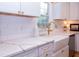 Close up featuring white cabinets, gold hardware, farmhouse sink, and elegant marble countertops at 760 Natchez Circle Cir, Mount Pleasant, SC 29464