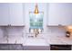 Close up featuring white cabinets, gold hardware, farmhouse sink, and elegant marble countertops at 760 Natchez Circle Cir, Mount Pleasant, SC 29464