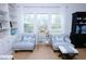 Bright living room boasts hardwood floors, custom built-ins, large windows, and comfortable seating at 760 Natchez Circle Cir, Mount Pleasant, SC 29464
