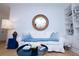 Bright living room with a round mirror, white sofa, and built-in shelving creating a cozy and inviting atmosphere at 760 Natchez Circle Cir, Mount Pleasant, SC 29464