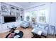Bright and airy living room with custom built-ins, stylish seating, hardwood floors, and natural light at 760 Natchez Circle Cir, Mount Pleasant, SC 29464