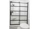 Modern shower with a black frame, glass doors, rain shower head, and a white bench at 760 Natchez Circle Cir, Mount Pleasant, SC 29464