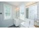 Bright bathroom featuring double sinks, modern fixtures, stylish lighting, and tiled walls at 810 Highway 61, Ridgeville, SC 29472