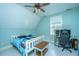 Bright bedroom features a bed, ceiling fan, and window providing natural light and desk at 810 Highway 61, Ridgeville, SC 29472