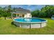 Relax in the backyard oasis with an above-ground pool and a charming home at 810 Highway 61, Ridgeville, SC 29472
