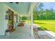 Inviting porch with rocking chairs and outdoor dining, perfect for relaxing and entertaining at 810 Highway 61, Ridgeville, SC 29472
