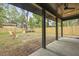 Spacious backyard with a covered patio, fan, new wooden fence, and fire pit area with Adirondack chairs at 868 Tripe St, Charleston, SC 29407