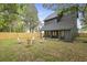 View of the backyard with a new wooden fence, and fire pit area with Adirondack chairs at 868 Tripe St, Charleston, SC 29407