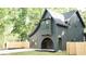 Charming new construction featuring dark siding, arched entryway, and craftsman details at 868 Tripe St, Charleston, SC 29407