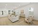 Open-concept living room features shiplap wall, light hardwood, and a white sofa at 868 Tripe St, Charleston, SC 29407