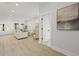 Bright, open-concept living area features shiplap walls and light hardwood flooring at 868 Tripe St, Charleston, SC 29407
