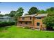 Home with large deck and backyard featuring green grass and mature trees at 919 Overview Ct, Mount Pleasant, SC 29464