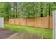 Backyard featuring a wooden fence, green lawn, and mature trees at 9646 Scarborough Ct, Summerville, SC 29485