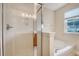 Shower and tub in a bright bathroom featuring tile floors and a window at 9646 Scarborough Ct, Summerville, SC 29485