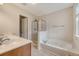 Bright bathroom featuring a glass-enclosed shower and separate jetted tub at 9646 Scarborough Ct, Summerville, SC 29485