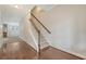 Bright foyer features hardwood floors with staircase and view of the kitchen at 9646 Scarborough Ct, Summerville, SC 29485