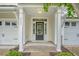 Welcoming front entrance with a black door, sidelights, and a covered porch at 9646 Scarborough Ct, Summerville, SC 29485