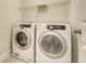 Efficient laundry room featuring a modern, front-load washer and dryer with overhead wire shelving at 9646 Scarborough Ct, Summerville, SC 29485