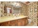 Classic bathroom with floral wallpaper, vanity, mirror, and a toilet at 103 Kenninghall Rd, Goose Creek, SC 29445