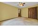 Inviting bedroom with a ceiling fan and a closet with wooden, folding doors at 103 Kenninghall Rd, Goose Creek, SC 29445