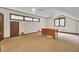 Large bonus room with paneled walls, a ceiling fan, and multiple windows at 103 Kenninghall Rd, Goose Creek, SC 29445