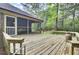 Large wooden deck extends from house into back yard and adjacent to screened porch at 103 Kenninghall Rd, Goose Creek, SC 29445