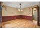 Spacious dining room features hardwood floors, natural lighting, and classic chandelier at 103 Kenninghall Rd, Goose Creek, SC 29445