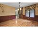 Elegant dining room features hardwood floors, natural lighting, and classic chandelier at 103 Kenninghall Rd, Goose Creek, SC 29445