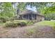 A home with a deck and screened porch is nestled amongst mature trees and lush landscaping at 103 Kenninghall Rd, Goose Creek, SC 29445