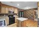 Cozy kitchen with black appliances, wooden cabinets, and an island at 103 Kenninghall Rd, Goose Creek, SC 29445