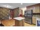 Eat-in kitchen features wood floors, center island, and stainless steel refrigerator at 103 Kenninghall Rd, Goose Creek, SC 29445