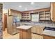 Kitchen with stainless steel refrigerator, wood cabinets, and tile backsplash at 103 Kenninghall Rd, Goose Creek, SC 29445