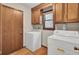 Functional laundry room with washer, dryer, and wood cabinets at 103 Kenninghall Rd, Goose Creek, SC 29445