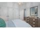 Bedroom featuring a light blue palette, a wooden dresser with decorative accessories, and double closet doors at 104 Orchard Blossom Ln, Summerville, SC 29485