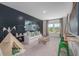 Spacious bonus room with shiplap accent wall, play tent, and unique rope swing feature at 104 Orchard Blossom Ln, Summerville, SC 29485
