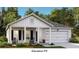 Charming single-Gathering home featuring a welcoming front porch and a convenient attached garage at 104 Orchard Blossom Ln, Summerville, SC 29485