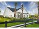 Charming single-story home with palm trees, white siding, dark shutters, and a well-manicured lawn for curb appeal at 104 Orchard Blossom Ln, Summerville, SC 29485