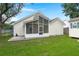 Spacious backyard featuring a screened porch and well-maintained lawn at 1042 Steelechase Ln, Hanahan, SC 29410